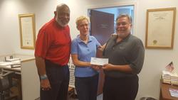 Local 277 member Brett Hulme presenting VOTE check to candidate Janine Brown.  Also pictured is GA State Rep. Dewey McClain.